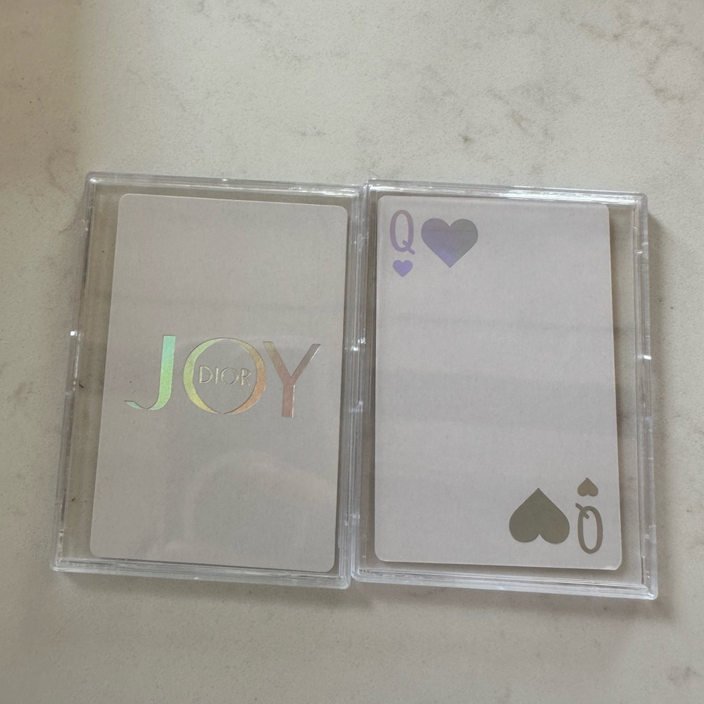 Assorted designer playing cards in case.